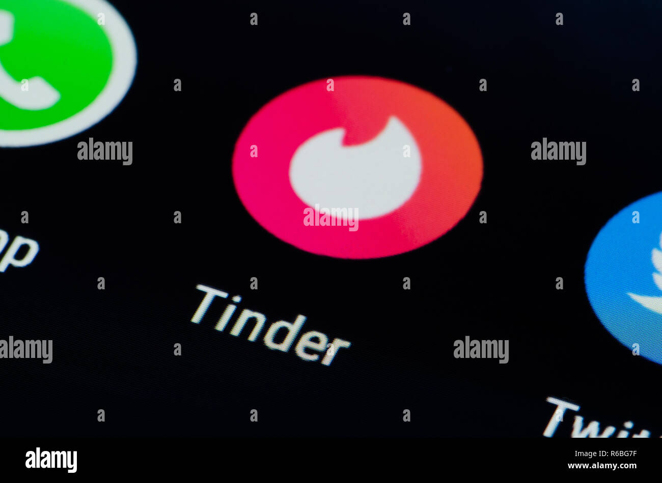 Tinder app on a smartphone, location-based social search mobile app that allows users to like or dislike other users, meeting, date, cybersex Stock Photo