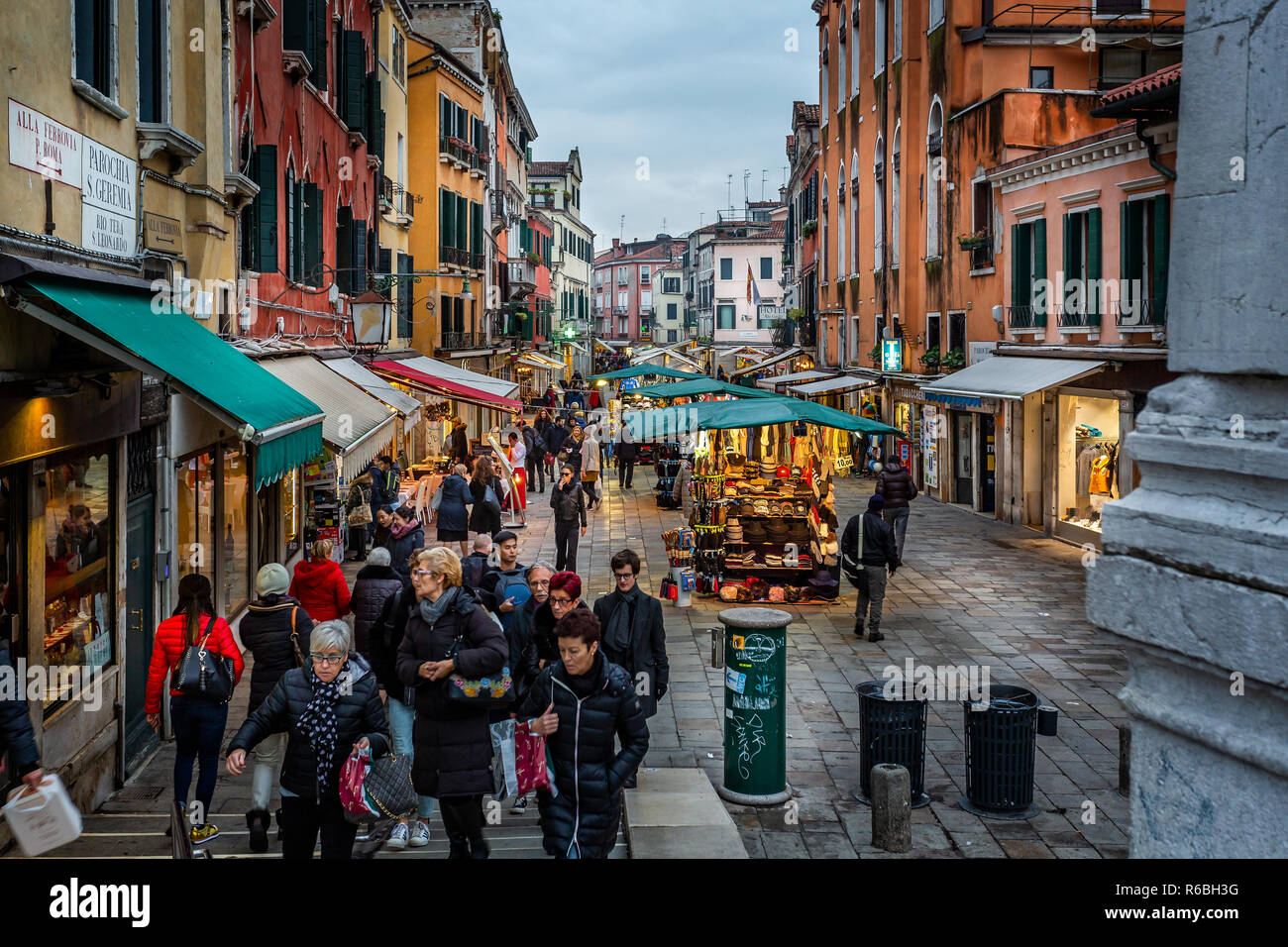 Illuminated market stalls on Venice street at night in Venice, Italy on