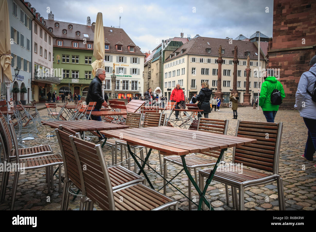 Freiburg im Breisgau, Germany December 31, 2017 table of a cafe in front of which people