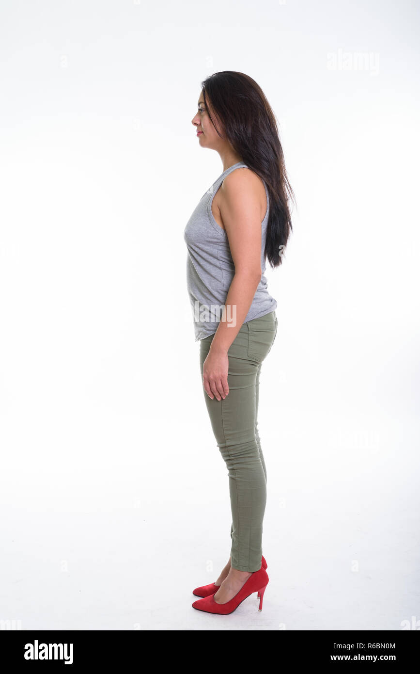 Full body shot profile view of beautiful woman standing against  Stock Photo