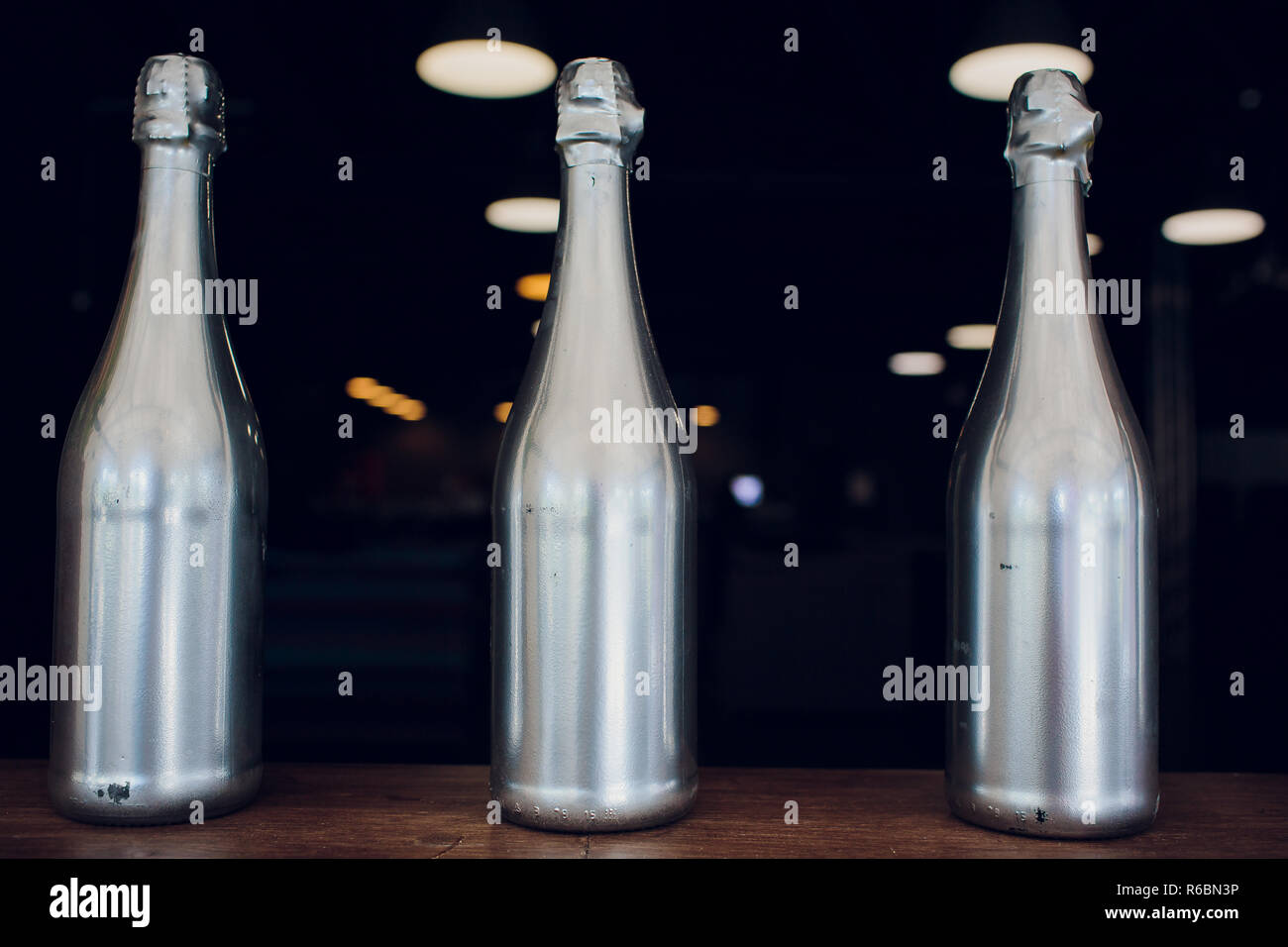 Wine champagne bottles silver on wooden shelf liquor store Stock Photo