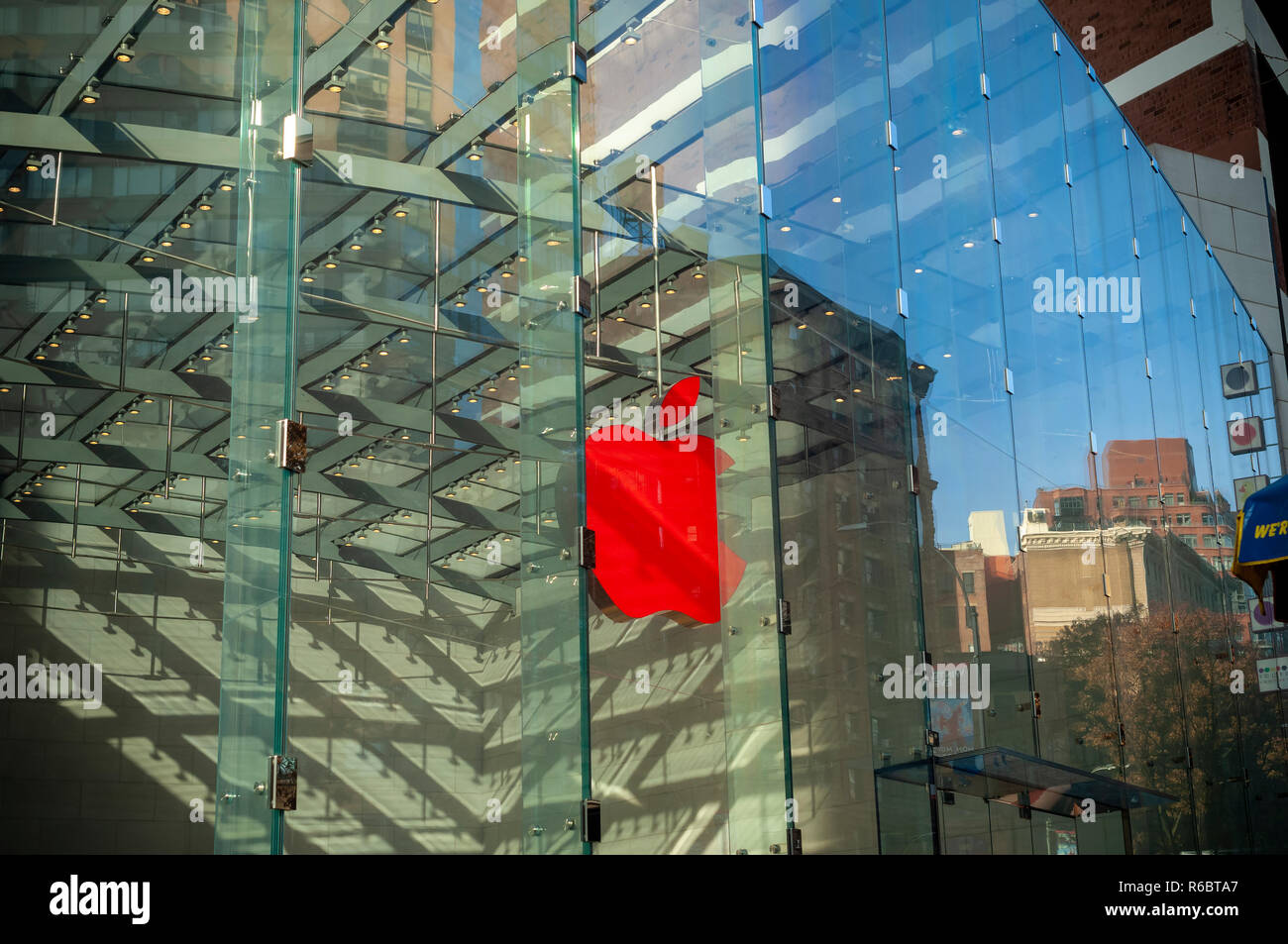 The Apple store in the Upper West Side neighborhood in New York displays its illuminated logo in (RED) marking World AIDS Day on Saturday, December 1, 2018. Apple will donate $1 for every transaction made with Apple Pay company wide to the Global Fund. 400 Apple stores have decorated their logo in (RED). (Â© Richard B. Levine) Stock Photo