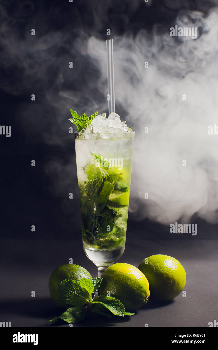 dark and stormy rum cocktail with Lime against background smoke Stock Photo