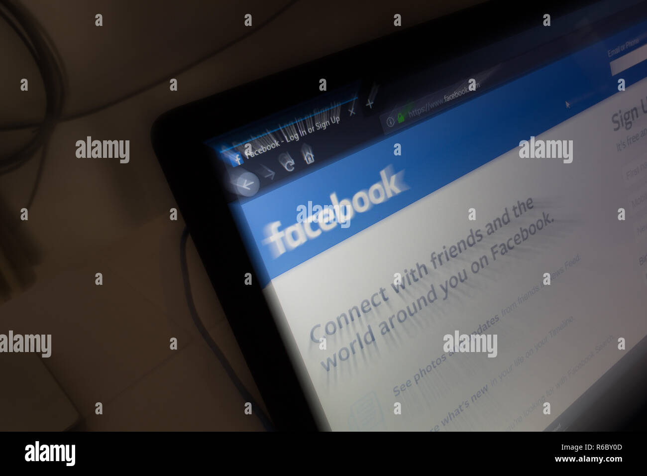 Facebook, logo on its website is shown on a laptop computer screen. Shoot in-camera zoom burst effect, long exposure Stock Photo