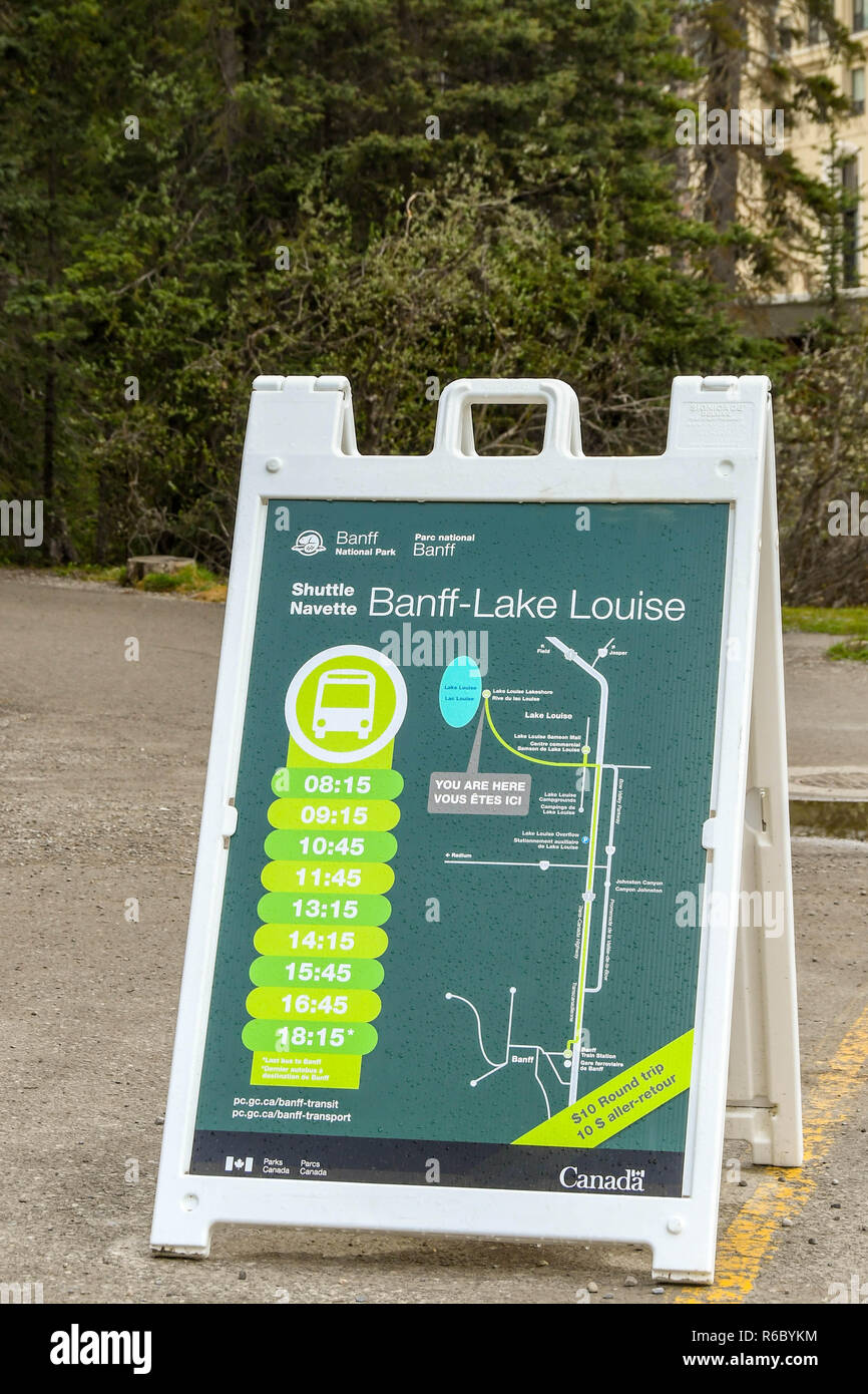 LAKE LOUISE, ALBERTA, CANADA - MAY 2018: Sign in the car park for Lake Louise showing visitors the timetable for the shuttle bus services to Banff. Stock Photo