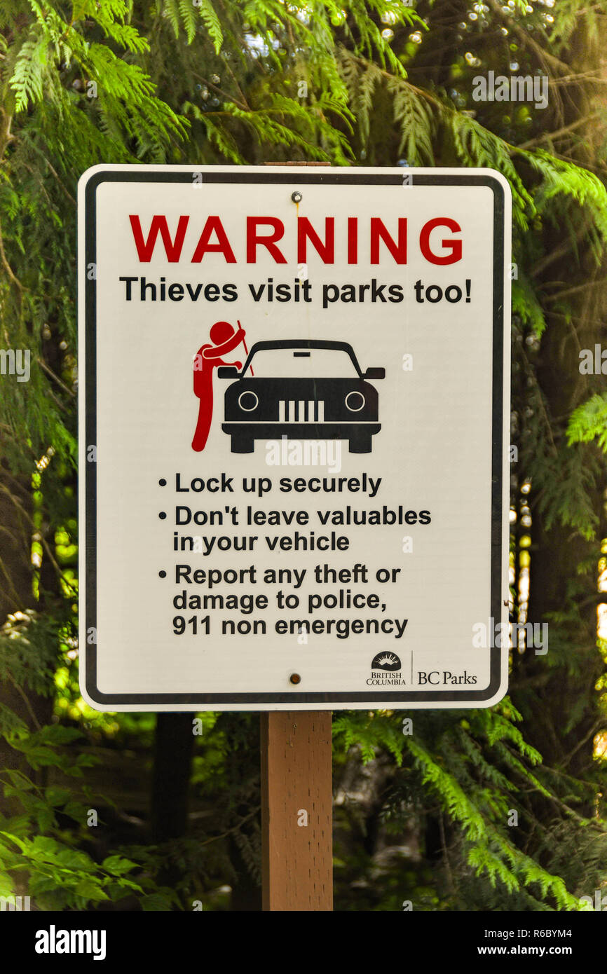 ALBERTA, CANADA - MAY 2018: Sign in a public car park in Alberta warning visitors to lock their cars to prevent theft. Stock Photo