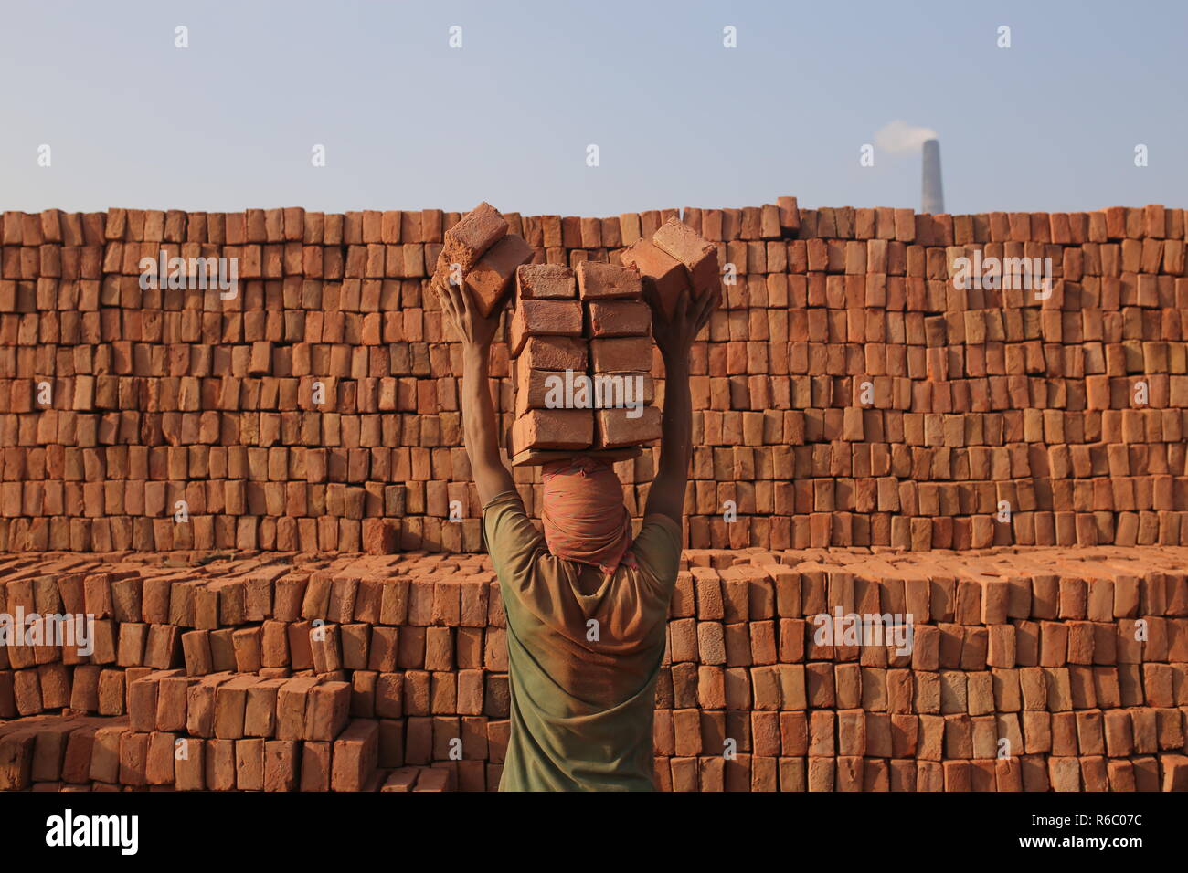 A labor is working at a brick field with unhealthy conditions in Dhaka ...