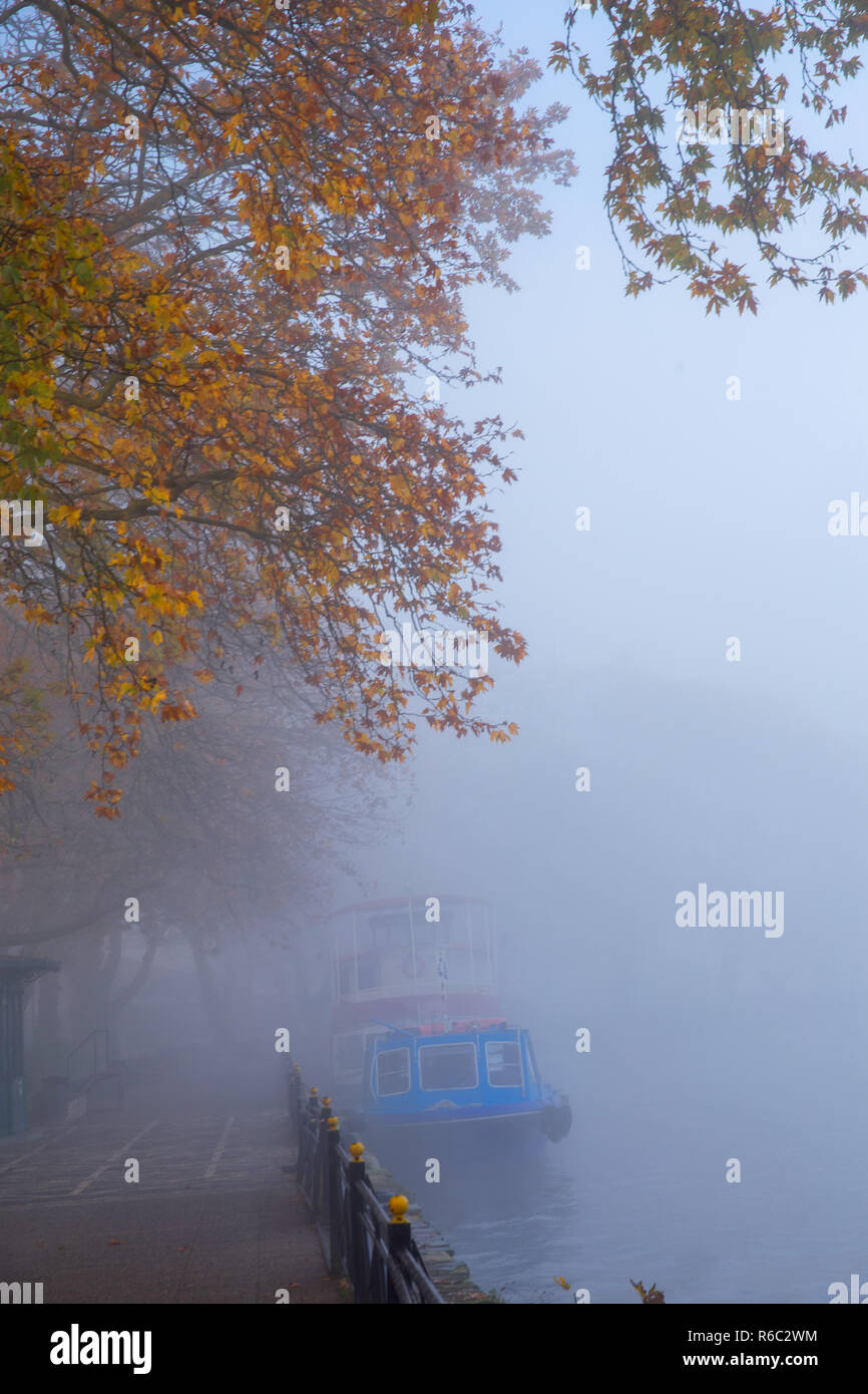boat in the fog foggy wheather in Ioannina city autumn season  greece Stock Photo