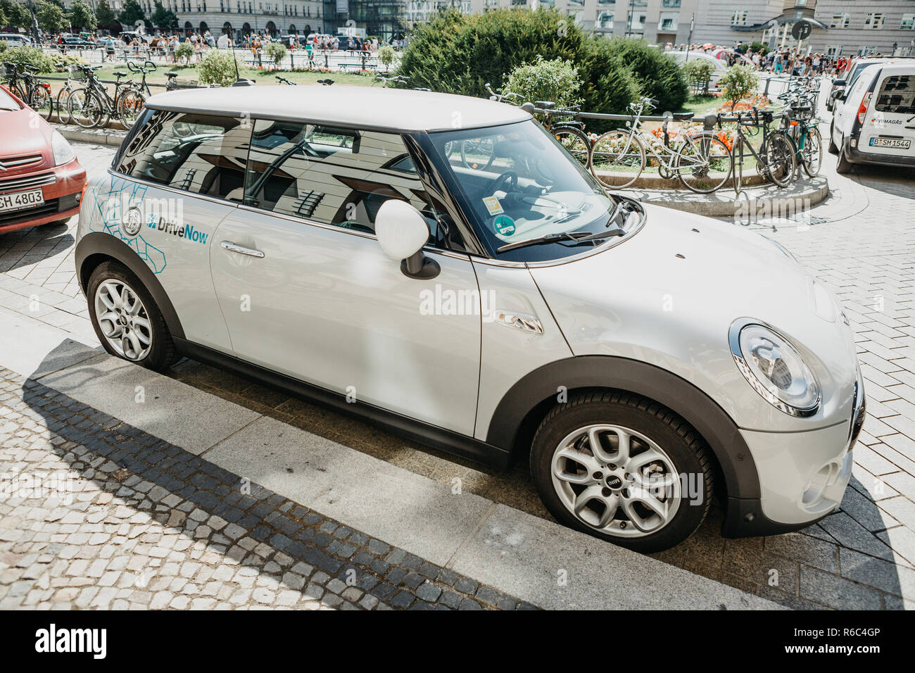 Germany, Berlin, September 05, 2018: A BMW electric car for the rental from a company called DriveNow is parked on a city street. Car rental takes place through a mobile application on a mobile phone. Stock Photo