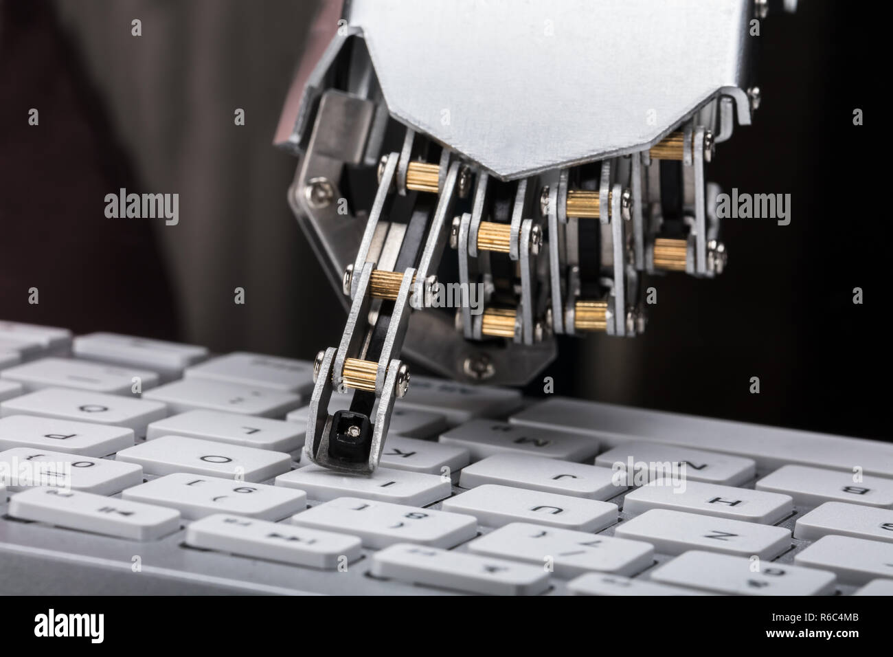Robotic Hand Typing On Keyboard Stock Photo