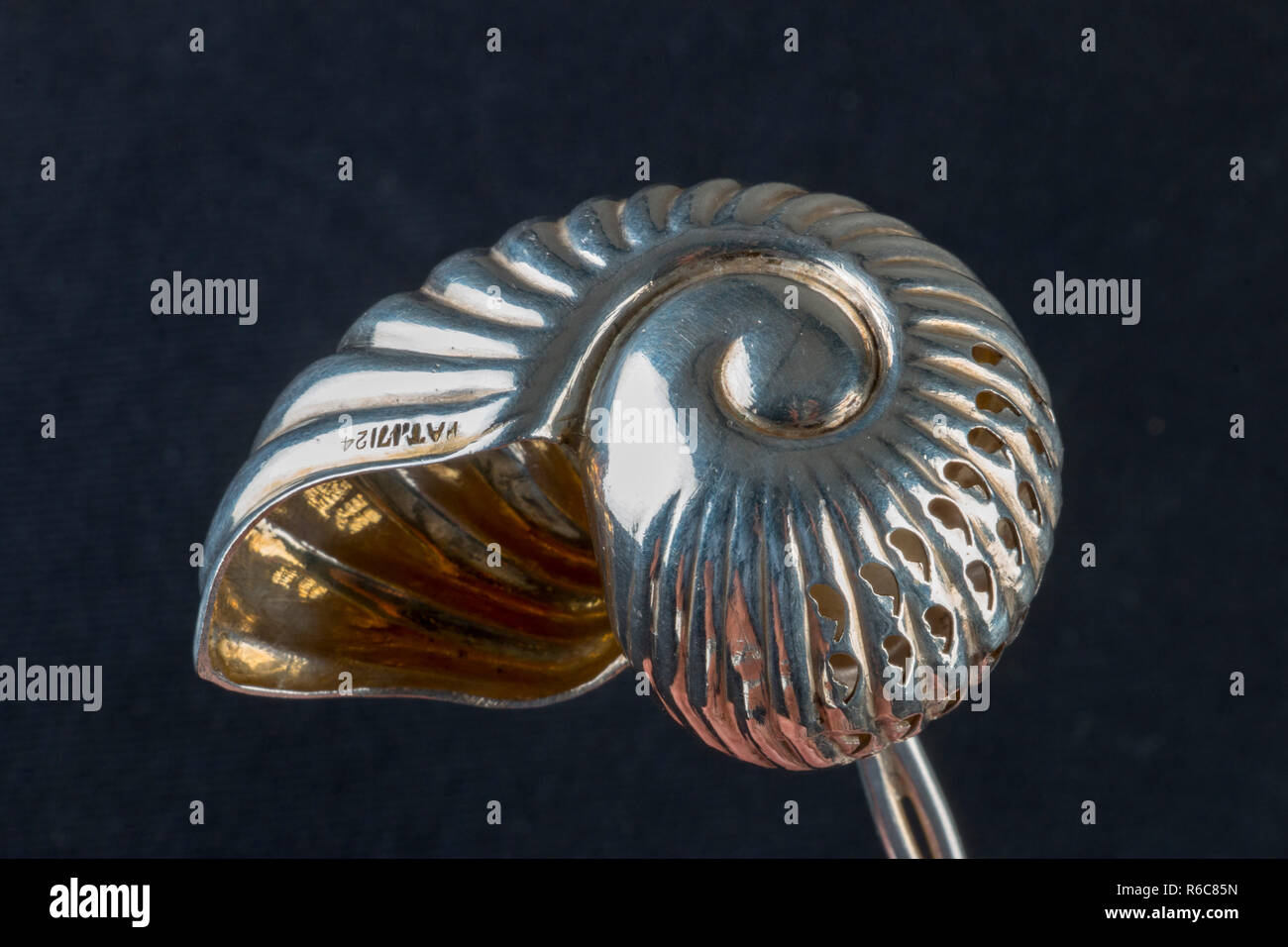 silver snail shaped spoon, gold lining, hallmark. Stock Photo