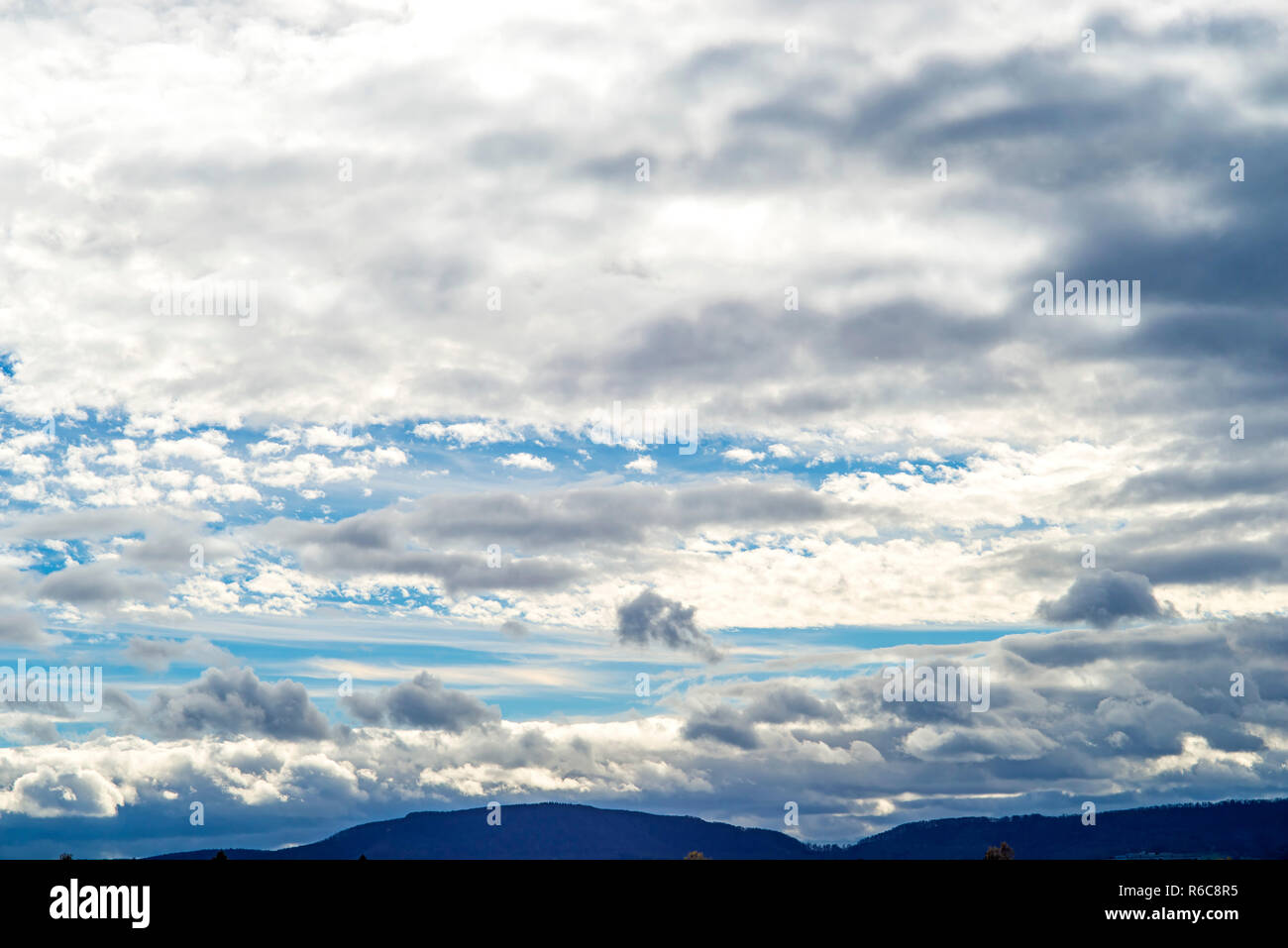 Blue Sky With Layers Of Clouds Stock Photo - Alamy