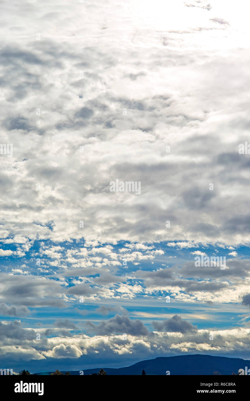 Blue Sky With Layers Of Clouds Stock Photo - Alamy