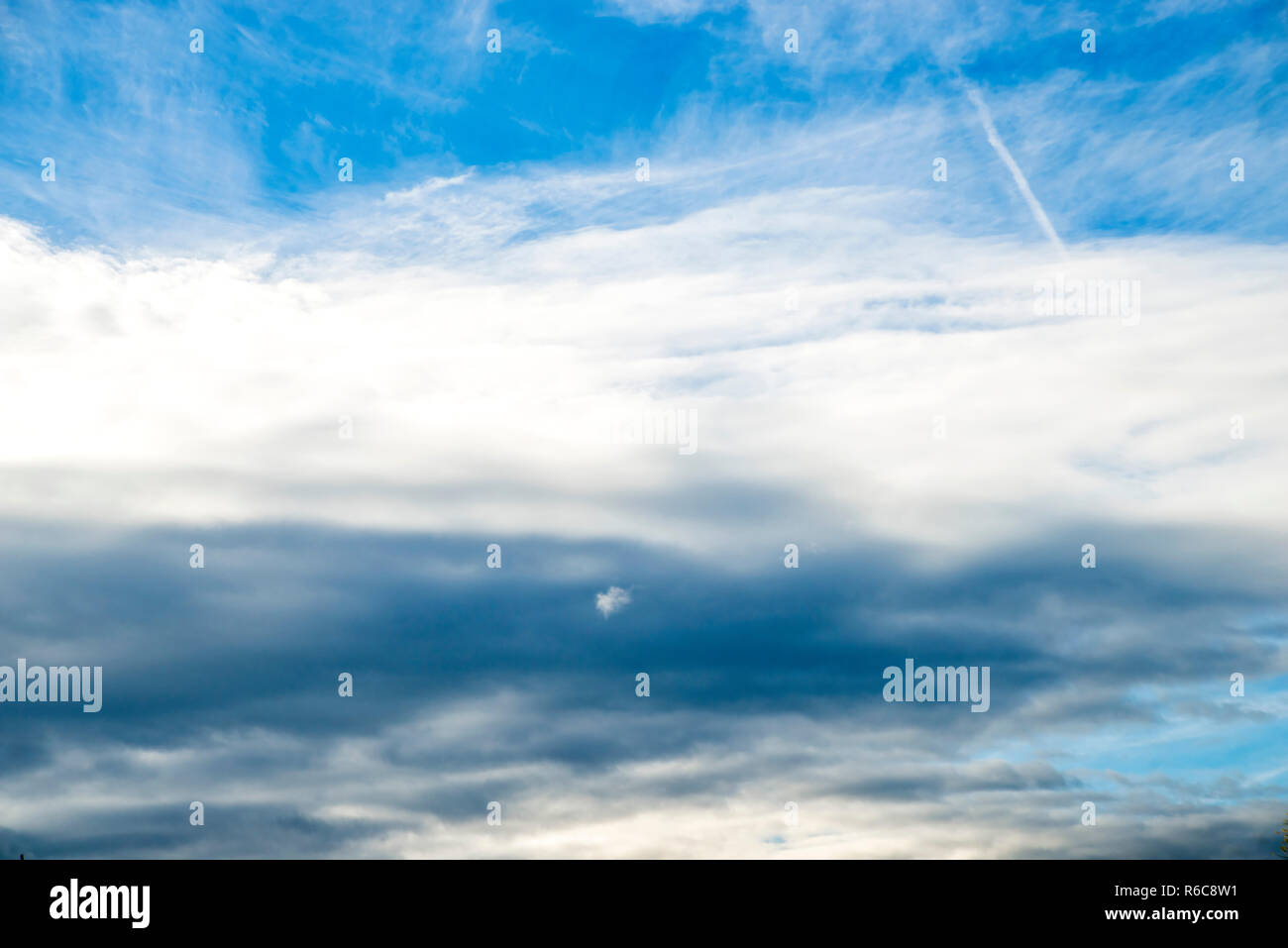 Blue Sky With Layers Of Clouds Stock Photo - Alamy