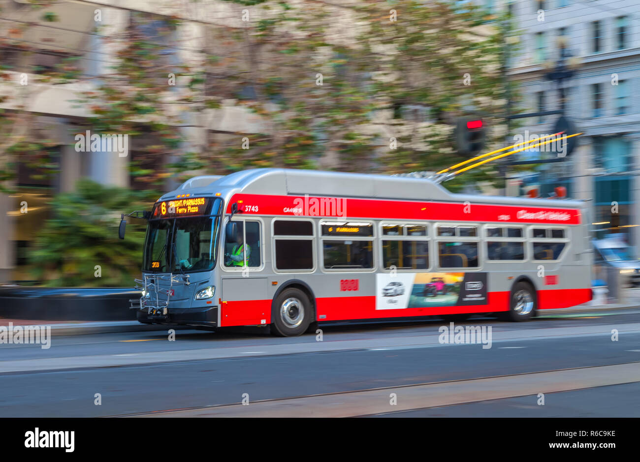 A trolley bus is running on the Market Street in San Francisco