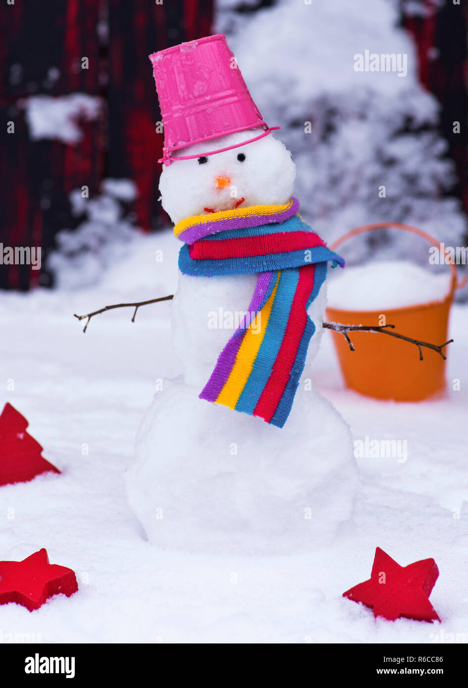 snowman with a bucket on his head on white snow Stock Photo - Alamy