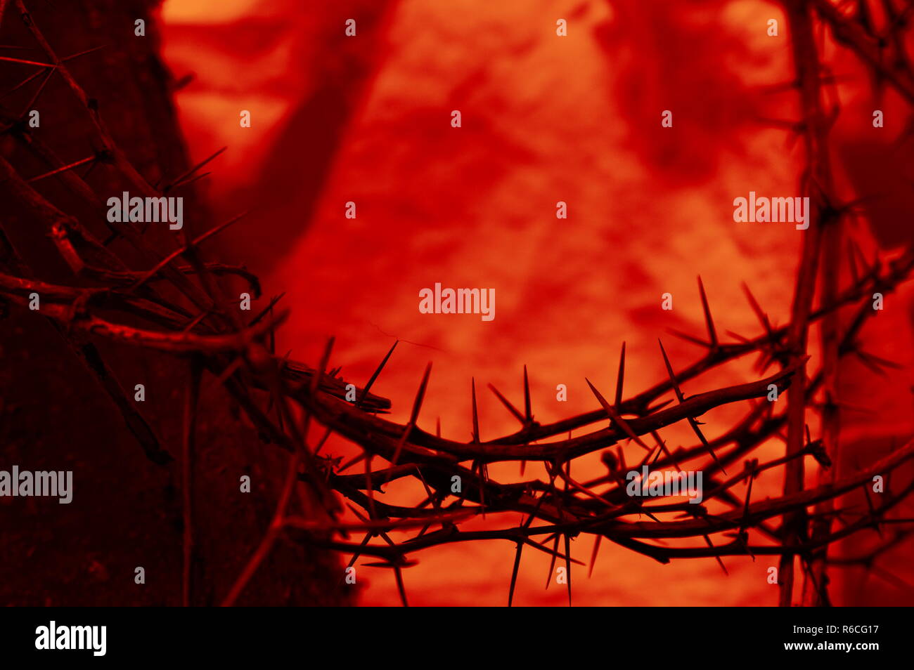 closeup of blood red crown of thorns on linen and a wooden beam from the cross Stock Photo
