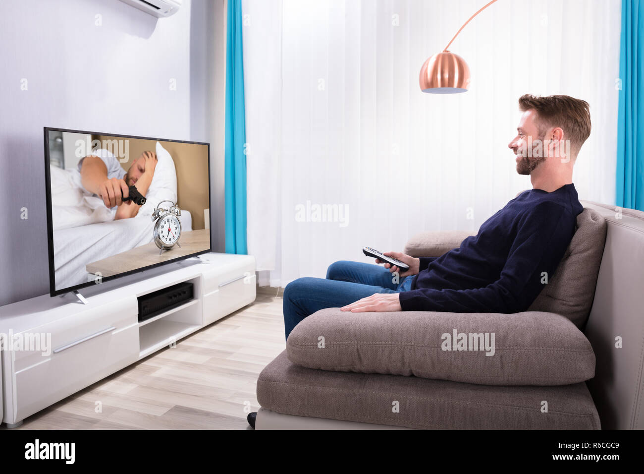 Man Sitting On Sofa Watching Television Stock Photo Alamy