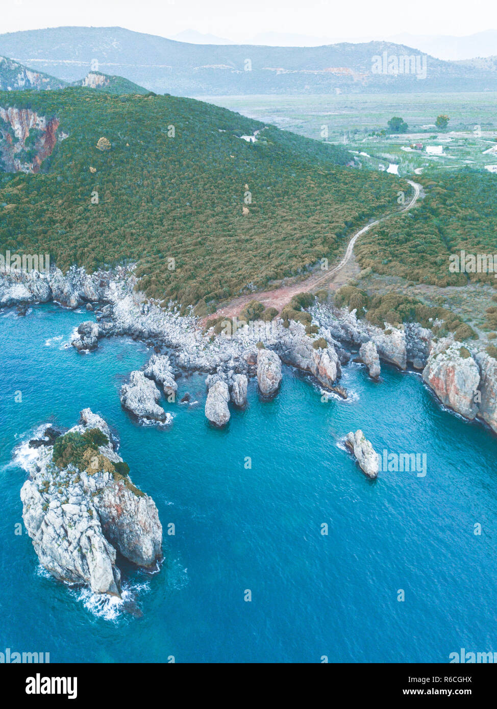 Small Island near the greek coast. Mediterranean nature during summer. Fantastic and wild landscape. Stock Photo