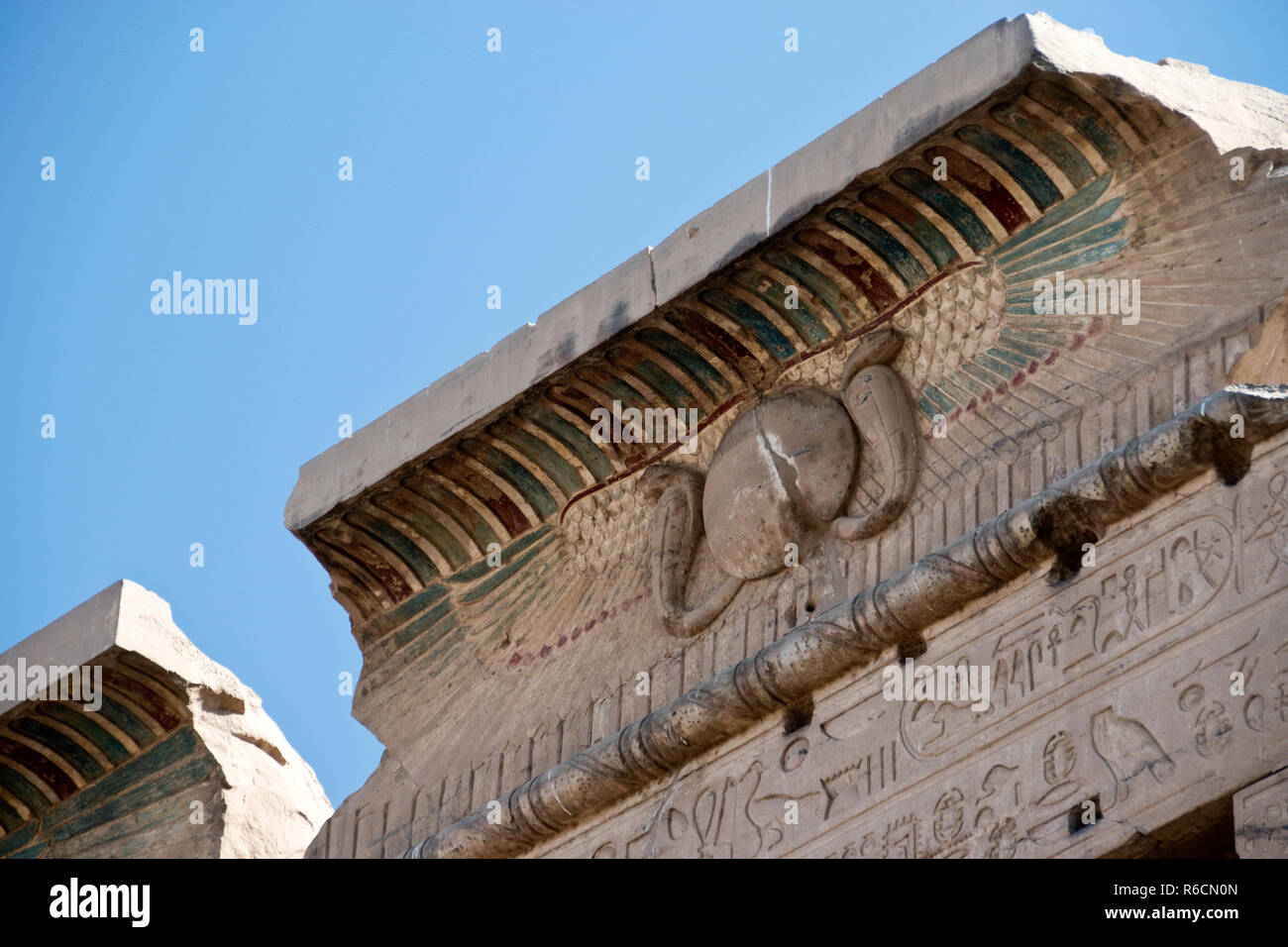 A Cavetto cornice with a winged sun, a symbol associated with divinity, royalty and power in the ancient Egypt, at the Temple of Kom Ombo, Egypt. Stock Photo