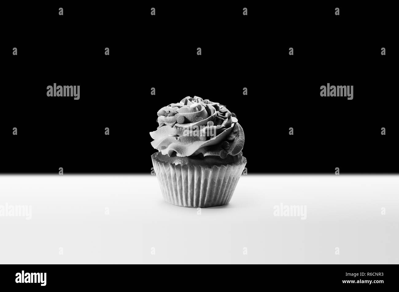 Cupcake with white frosting, monochrome studio shot Stock Photo