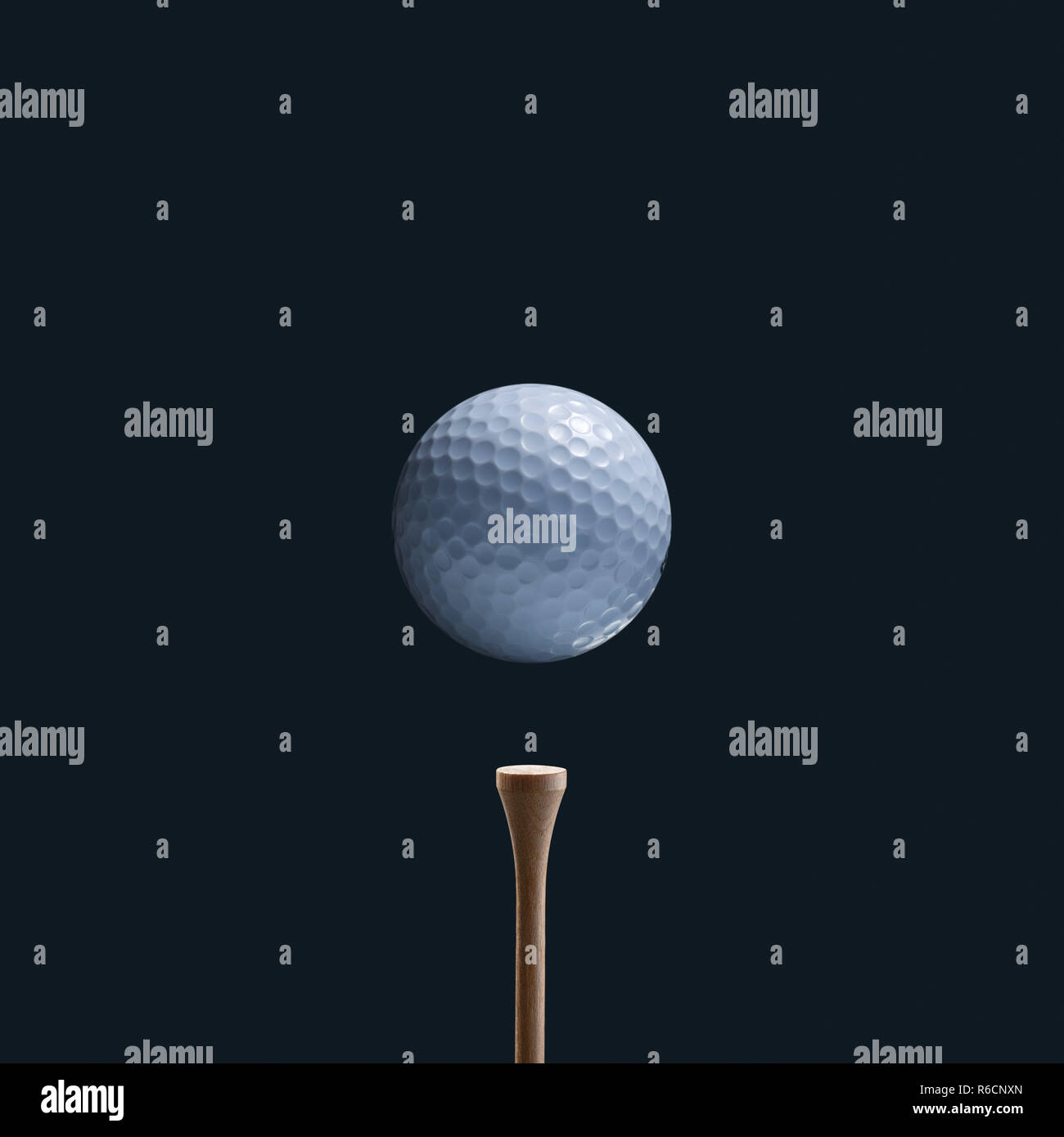 Cropped close up of dimpled white golf ball hovering over a wooden tee Stock Photo