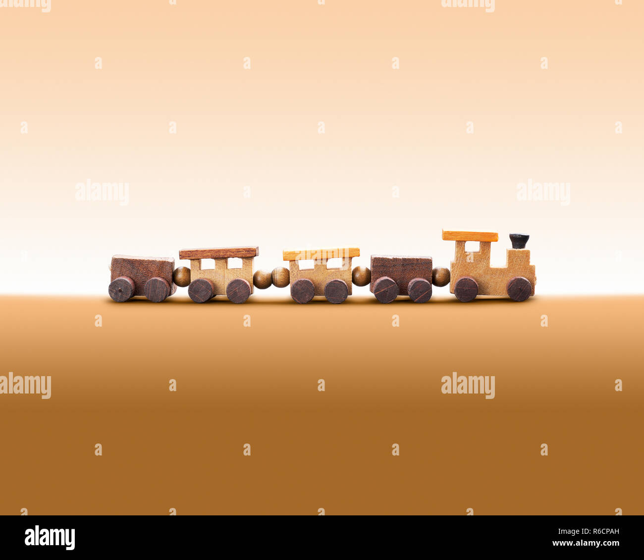 Natural wooden toy train against a plain background Stock Photo