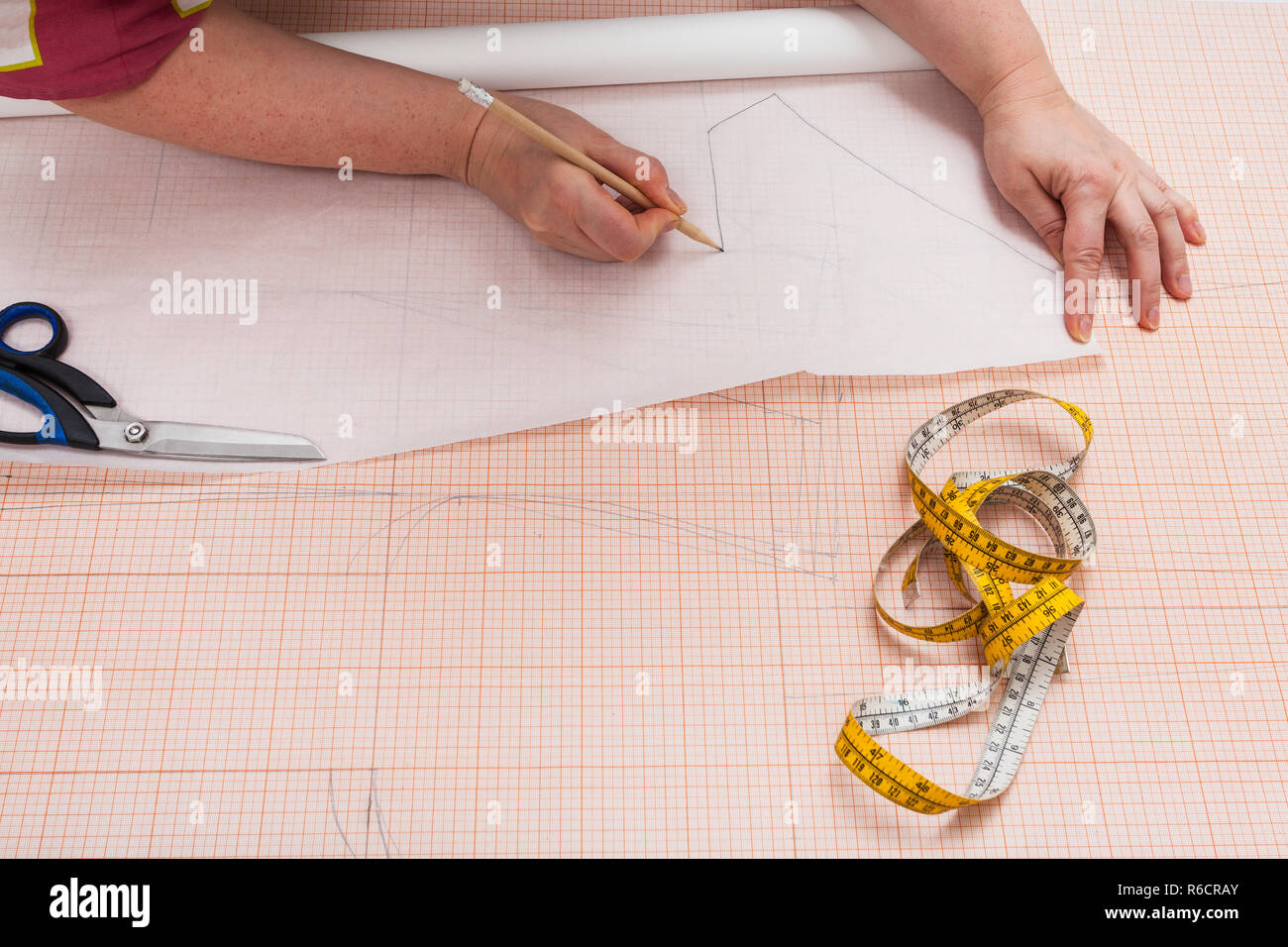 tailor tracing a clothing pattern on tracing-paper Stock Photo - Alamy