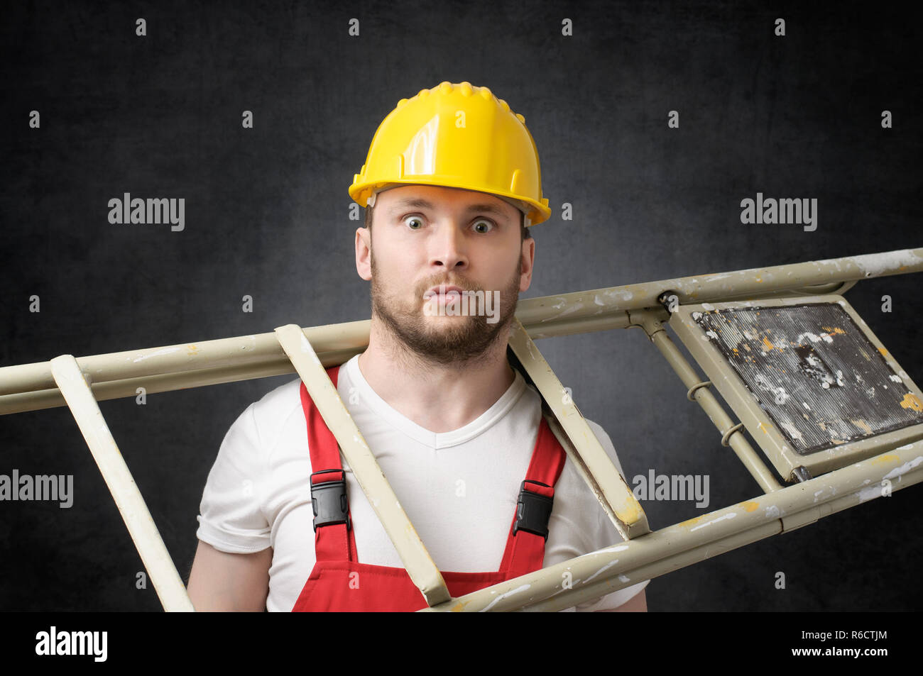 Clumsy worker with ladder Stock Photo