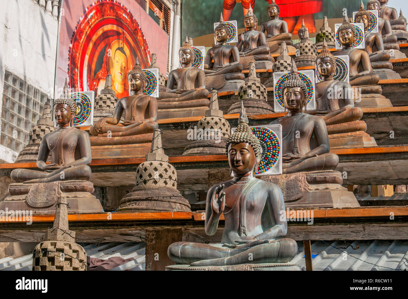 Statues Of The Buddha In The Lotus Position, Gangaramaya Buddhist Temple, Colombo, Sri Lanka Stock Photo