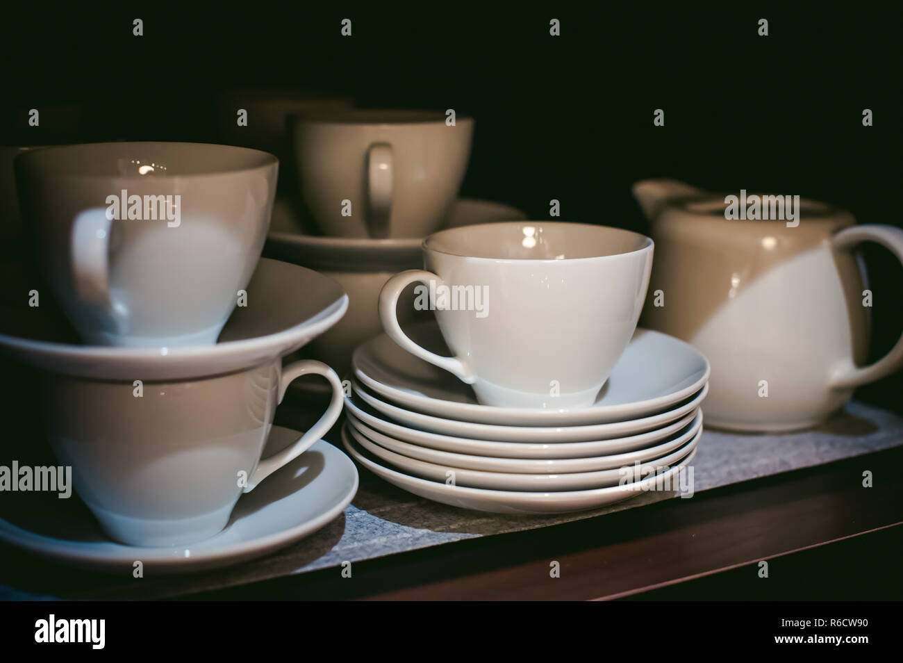 Cup And Saucer Set Stand In The Closet On The Shelf Stock Photo
