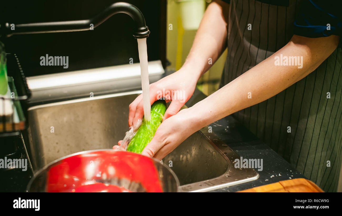 woman washing vegetables for cooking, water under the tap Stock Photo ...
