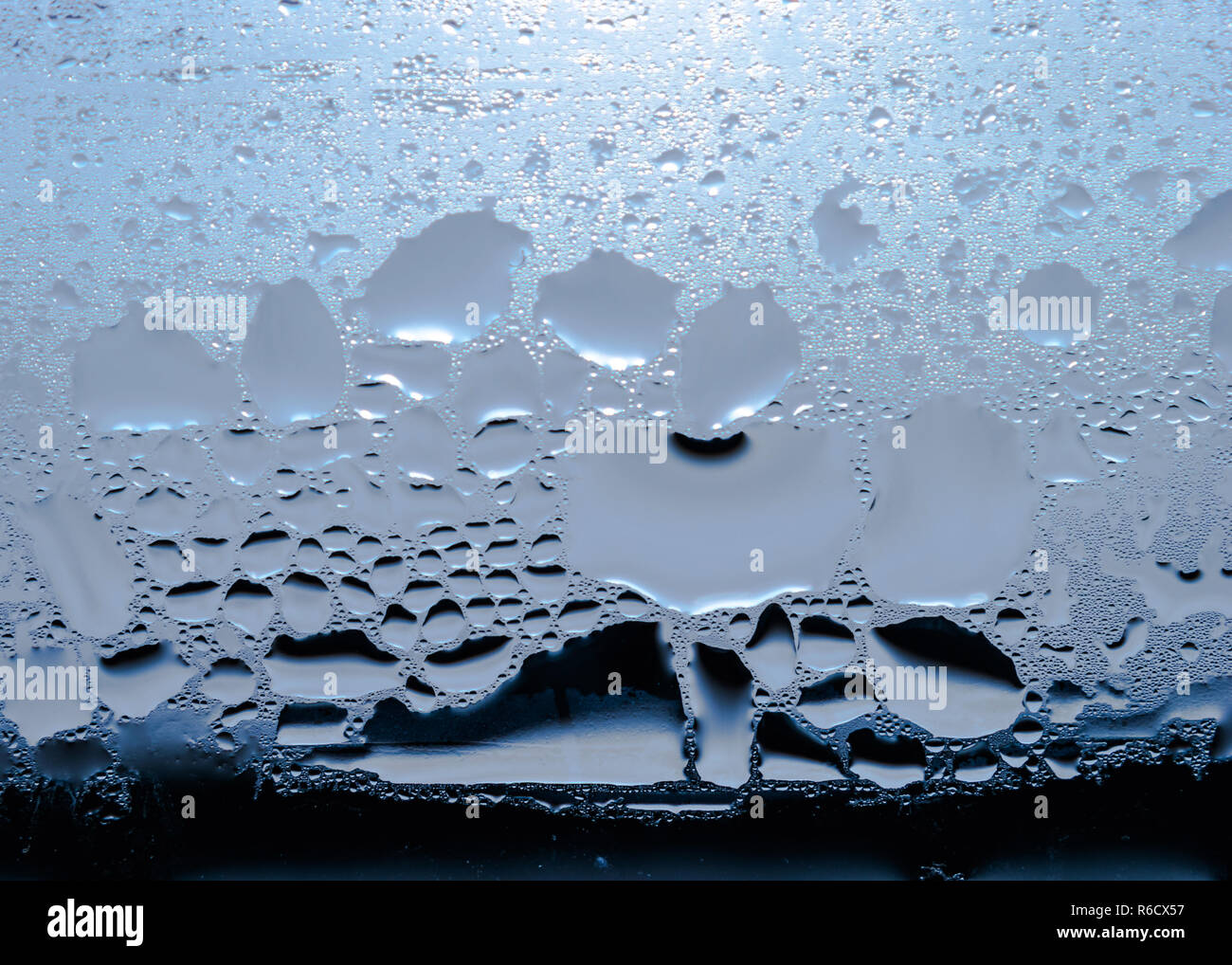 Condensation, Vapor, Rain, Water Drops Of Various Sizes On A Glass Surface. Stock Photo