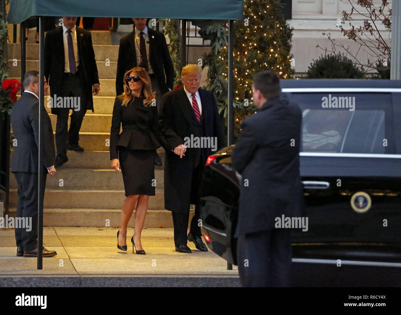 Washington, District of Columbia, USA. 4th Dec, 2018. United States President Donald J. Trump and First lady Melania Trump depart Blair House following a brief visit with former US President George W. Bush and wife, former first lady Laura Bush, where the two are staying prior to the State Funeral tomorrow for former US President George H.W. Bush, in Washington, DC, December 4, 2018 Credit: Martin H. Simon/CNP/ZUMA Wire/Alamy Live News Stock Photo