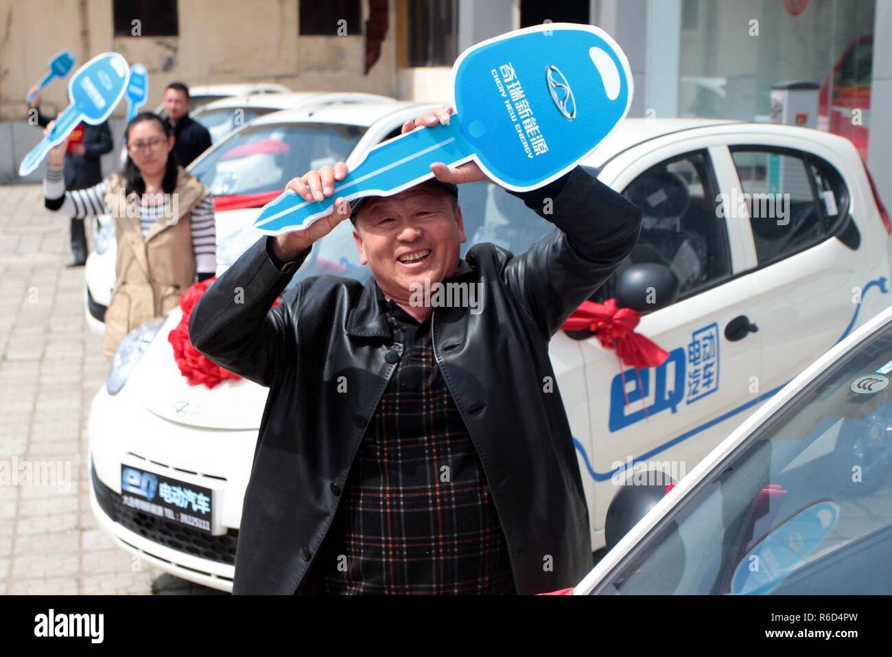 (181205) -- BEIJING, Dec. 5, 2018 (Xinhua) -- Owners of electric cars show their keys at a new energy vehicle display center in Dalian, northeast China's Liaoning Province, April 18, 2015. China has been delivering on its commitment to the international community on climate change by continuously shifting to a more green economy over the past years. New energy-rich regions like Inner Mongolia and Ningxia are sending more electricity generated from clean energy to the country's bustling east to help reduce the country's heavy reliance on coal in the fight against pollution and coping wi Stock Photo