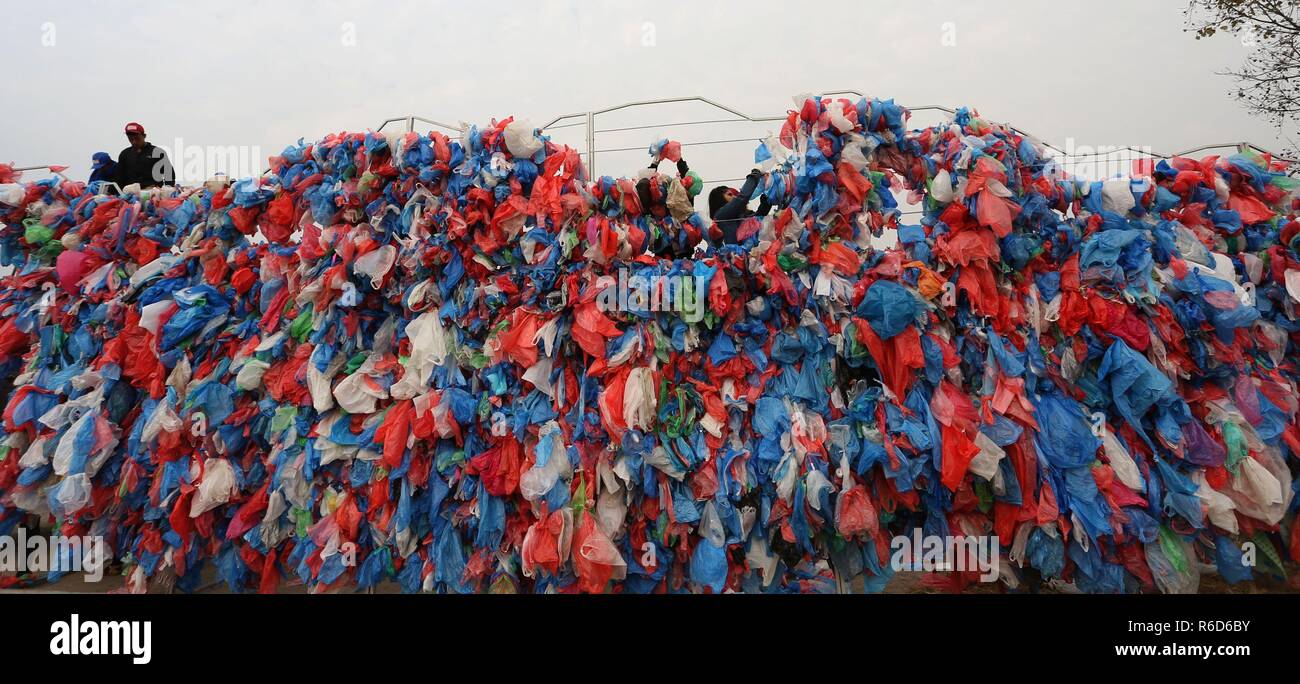 Kathmandu, Nepal. 5th Dec, 2018. People tie up plastic bags to make the