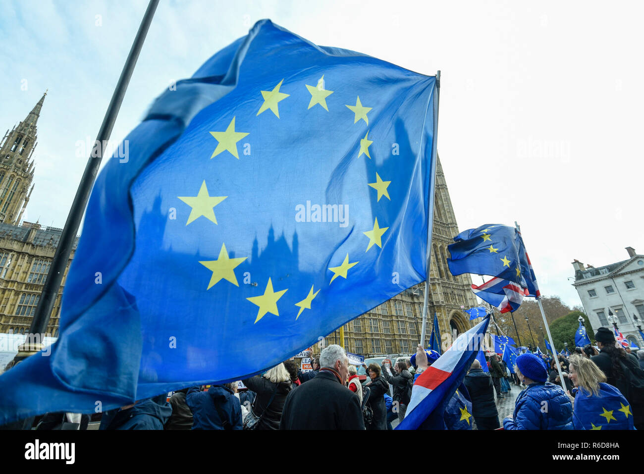 London, UK.  5 December 2018.  European flags held aloft by anti-Brexit supporters demonstrating outside the Houses of Parliament.  MPs are debating Theresa May's Brexit deal with the European Union ahead of the meaningful vote of December 11.  Credit: Stephen Chung / Alamy Live News Stock Photo