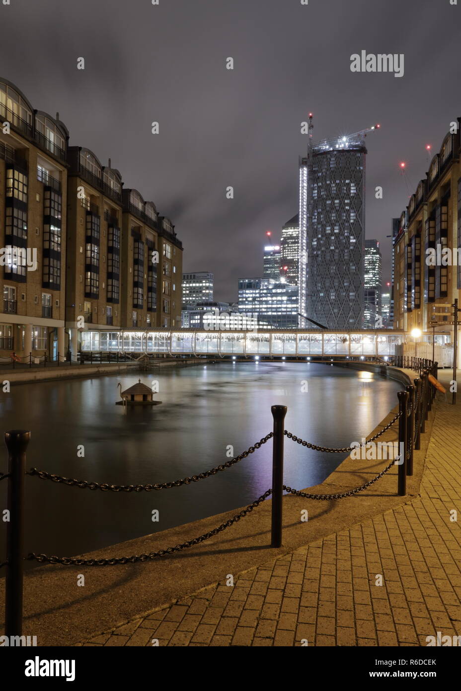 Doubletree Docklands Nelson Dock Pier next to riverside Thames. Night London with beautiful reflections and building lights. Stock Photo