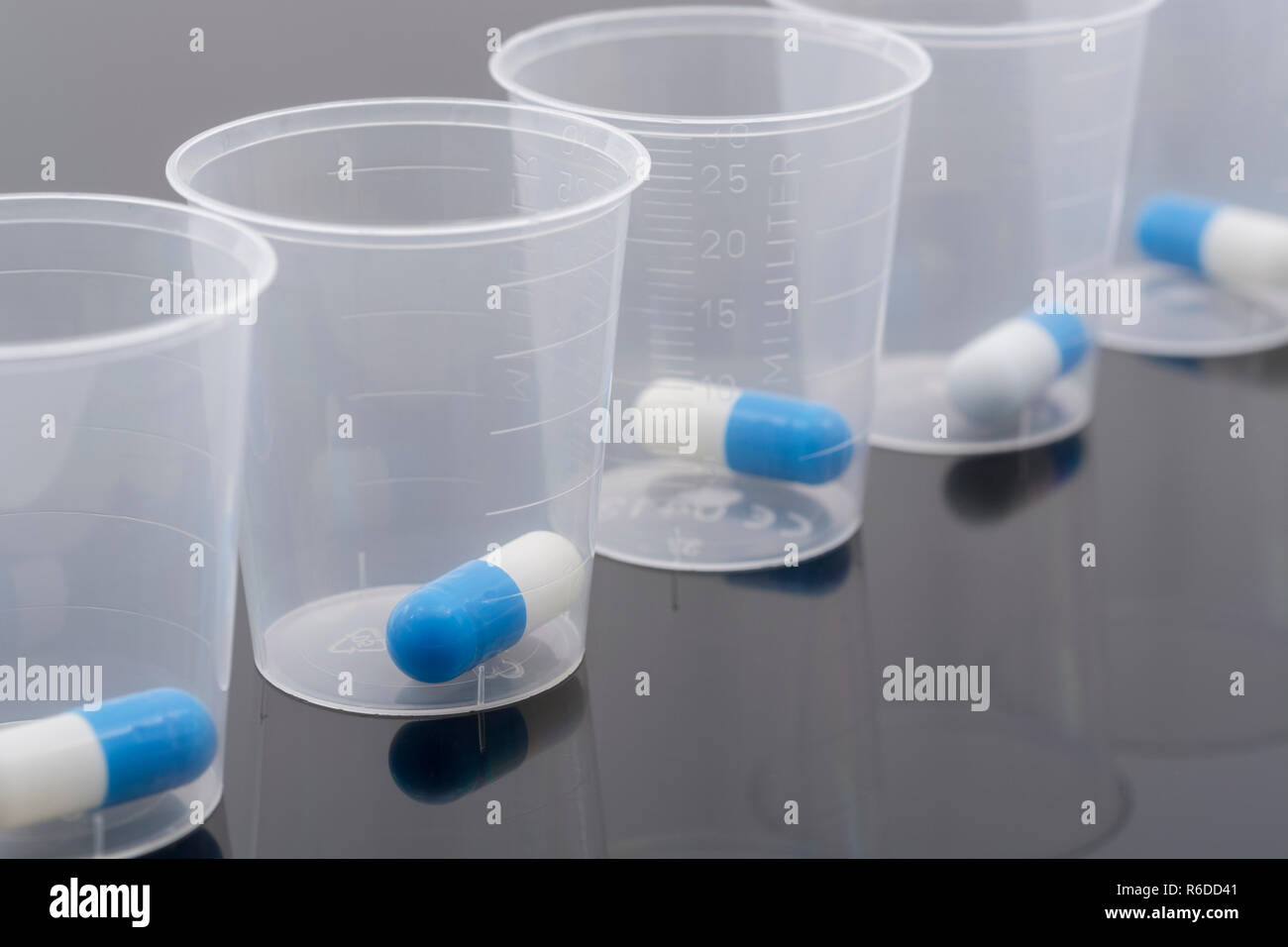 Big pharma medication concept. Blue and white capsules pills in plastic
