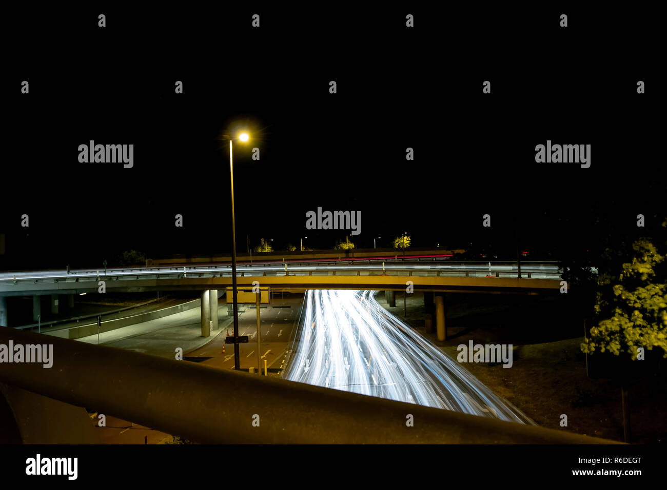 Highway With Bridge And Car Light Trails At Night Stock Photo - Alamy