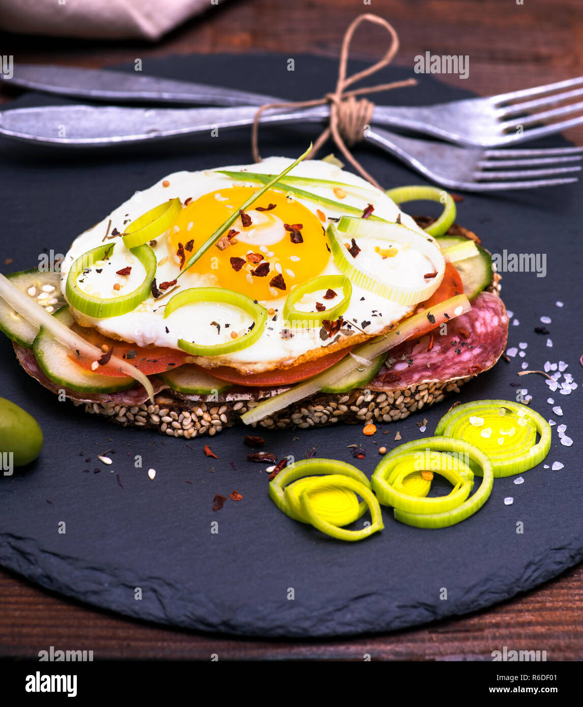 sandwich with fried egg, sausage salami and vegetables Stock Photo Alamy