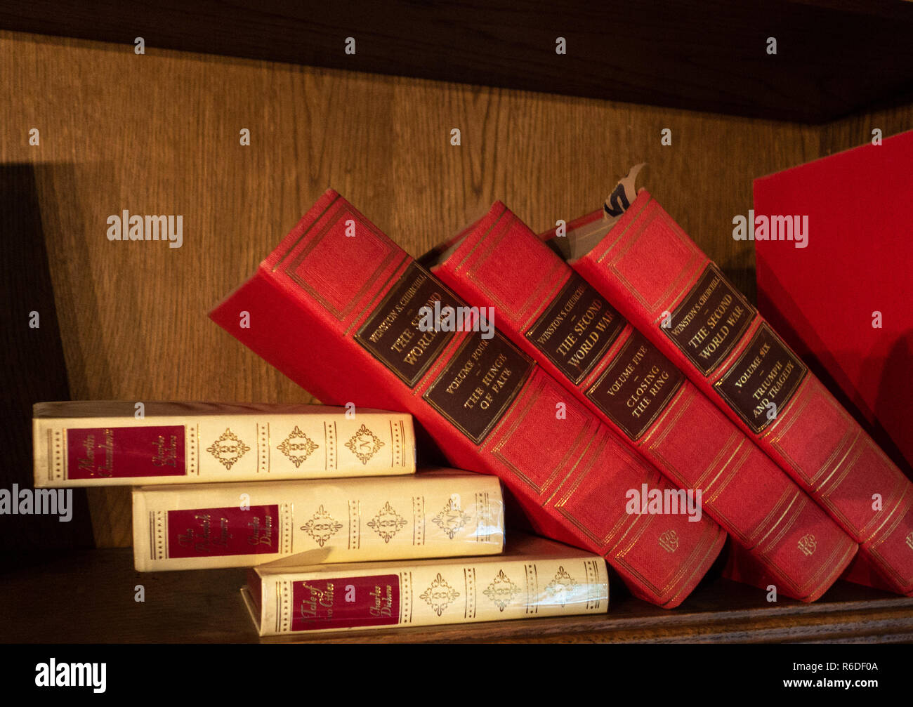 Old Red Leather bound books on a bookshelf Stock Photo