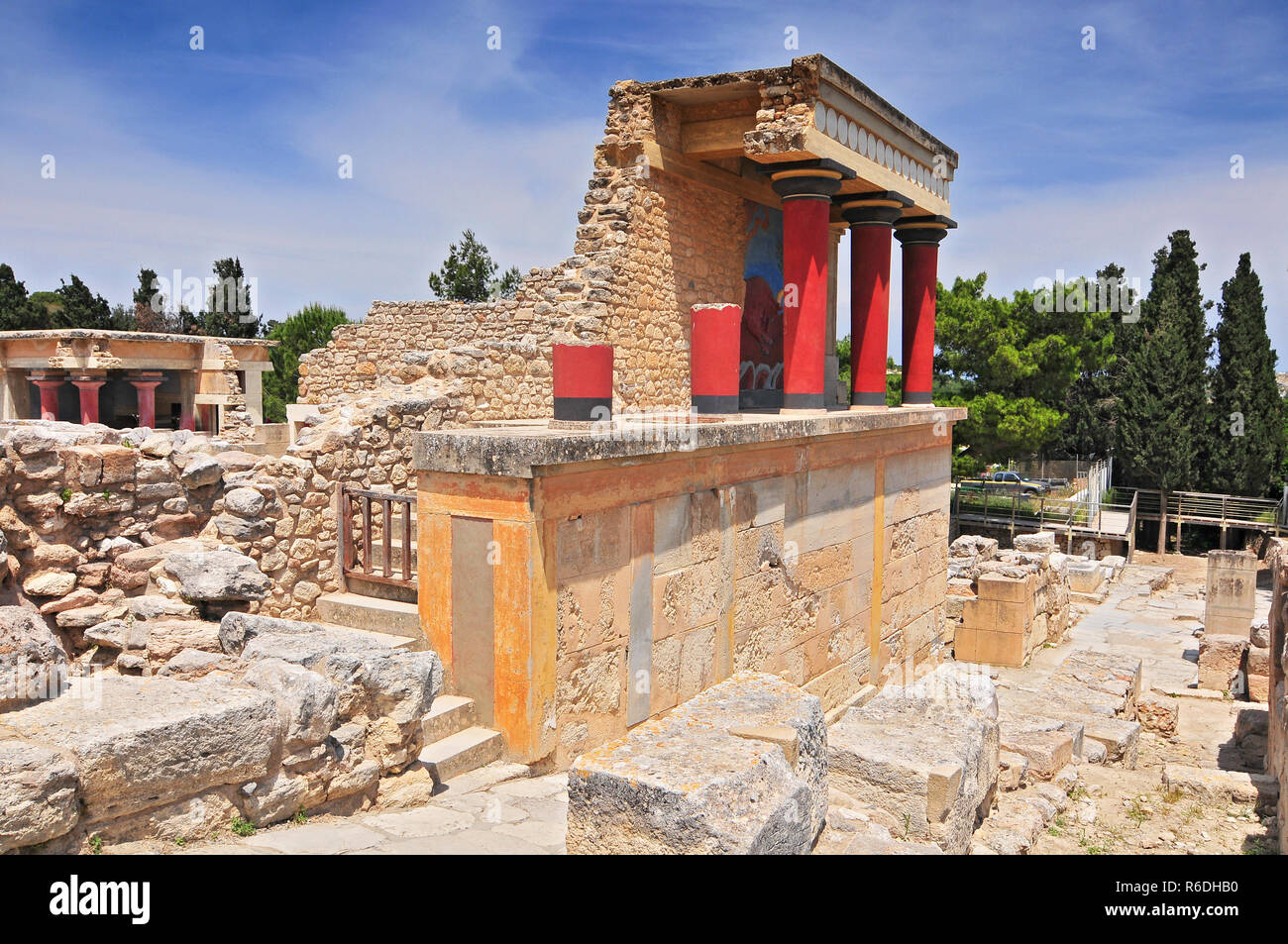 Partial View Of The Minoan Palace Of Knossos With Characteristic Columns And A Fresco Of A Bull Behind Crete, Greece Stock Photo