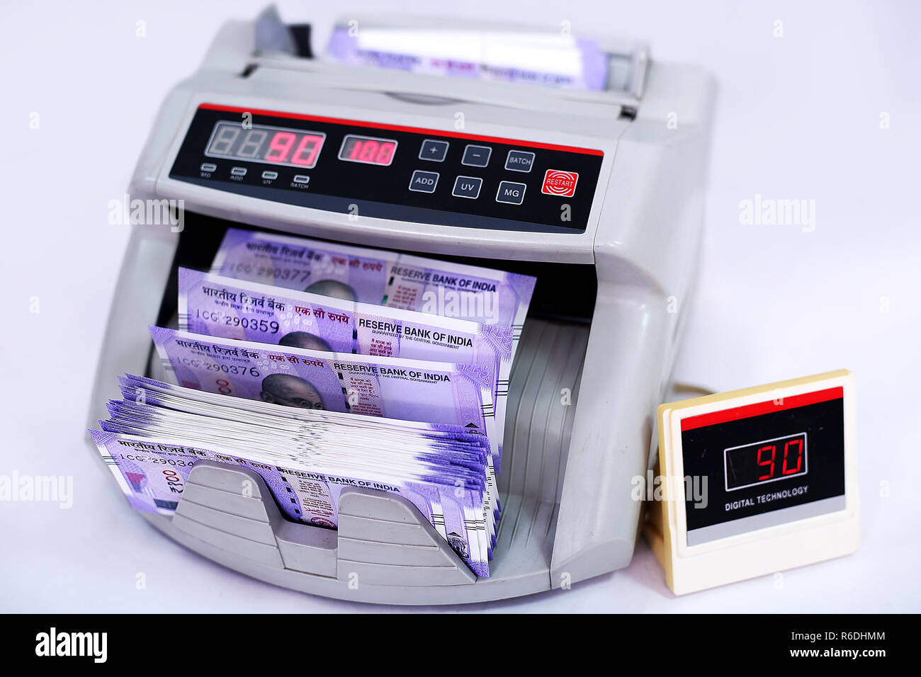 New Indian currency notes in the cash counting machine. Isolated on the white background Stock