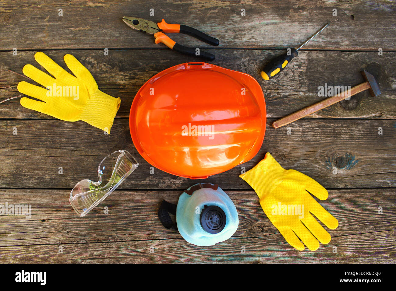 Construction tools and means of protection on an old wooden background. Top view. Flat lay. Stock Photo