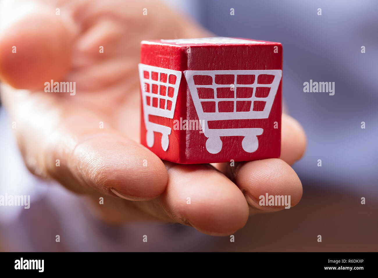 Person's Hand Holding Red Wooden Block Stock Photo - Alamy