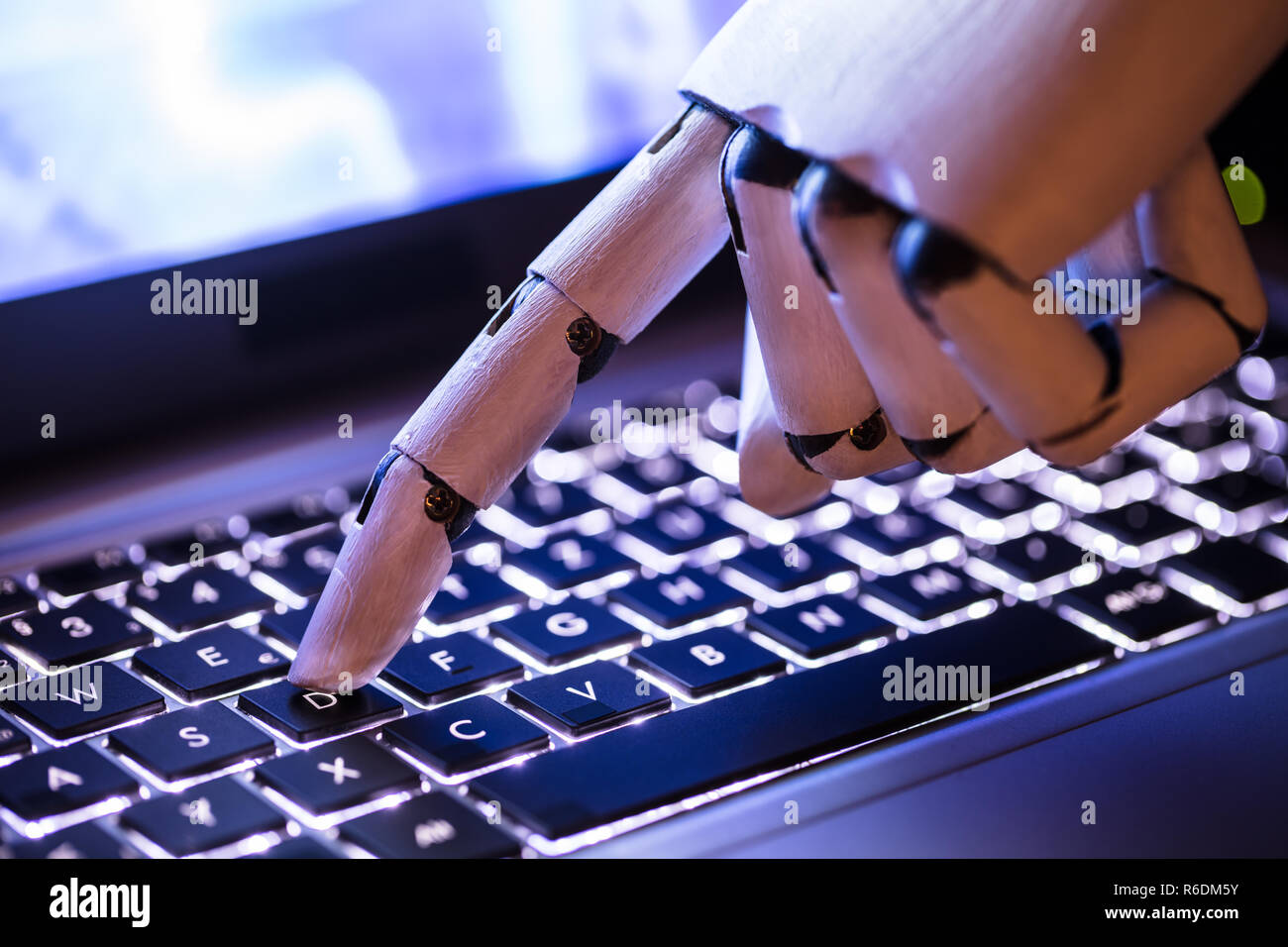 Robot Typing On Laptop Stock Photo