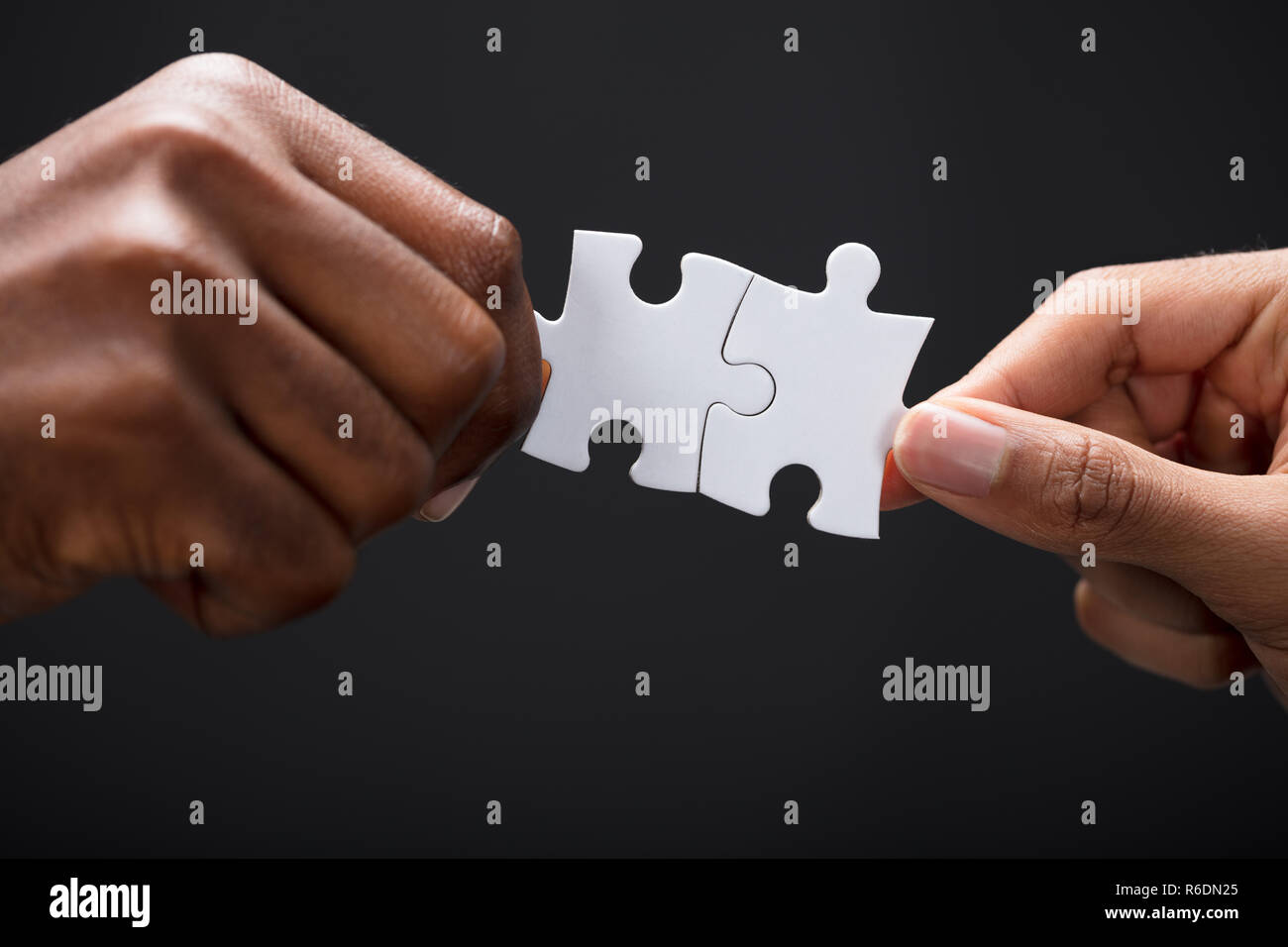 Hands Combining White Puzzle Pieces Stock Photo - Alamy