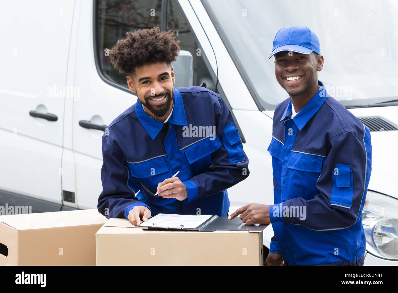 Delivery Man Writing On The Clipboard Stock Photo