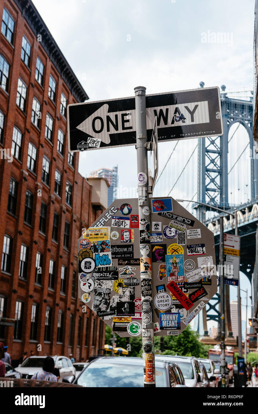 New York City, USA - June 24, 2018: Iconic view of Manhattan Bridge from Washington Street in Brooklyn a sunny day of summer, One way street sign on f Stock Photo